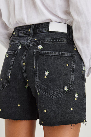 The vintage-inspired Mesa is a high-rise denim cut-off with a slightly longer inseam and relaxed fit. Finished with specialty daisy embroidery, a raw hem and button fly.