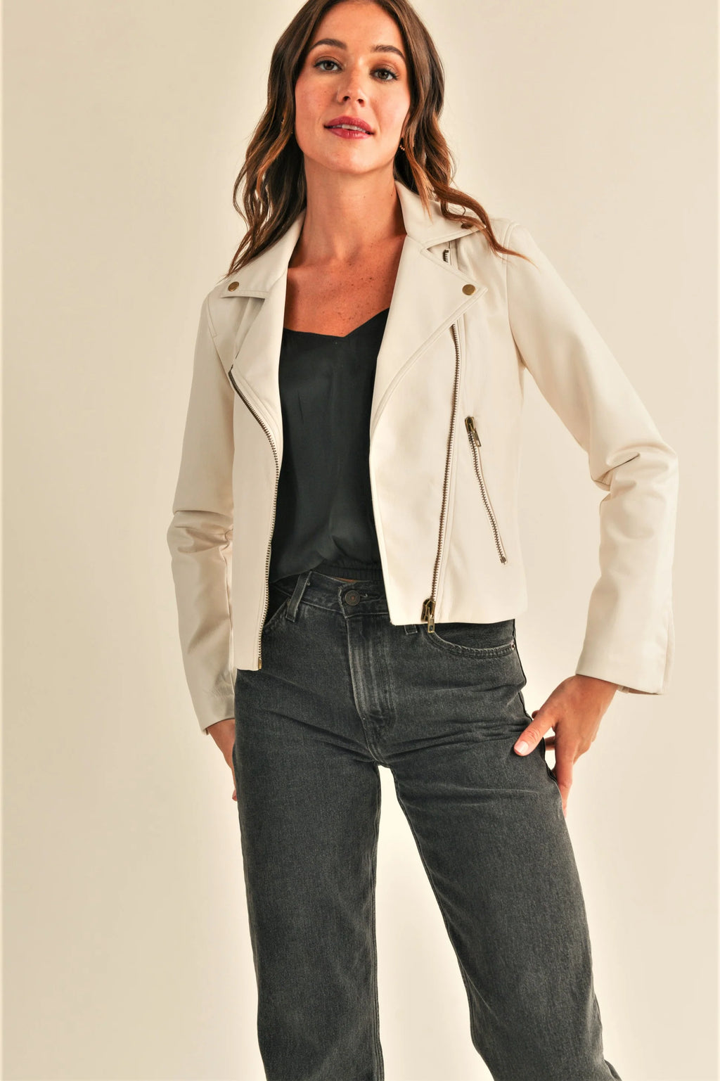 The Juno Leather Jacket is a biker style jacket made with high quality, faux leather material. Its antique gold zippers add subtle touches of sophistication, while the notched collar and long sleeves provide a timeless look. The form fitting design and high hip bone length make it a flattering choice for any outfit.