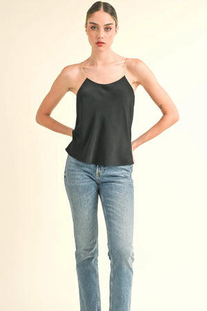 Get ready to turn heads with the Reset by Jane | Sophia Cami Top. Featuring an open back and chain straps, this top adds a touch of edgy elegance to any outfit. The chain wrap back detail and regular fit provide a flattering silhouette, while the solid color silky fabric elevates your style game. Truly a must-have piece for any fashion-forward individual!