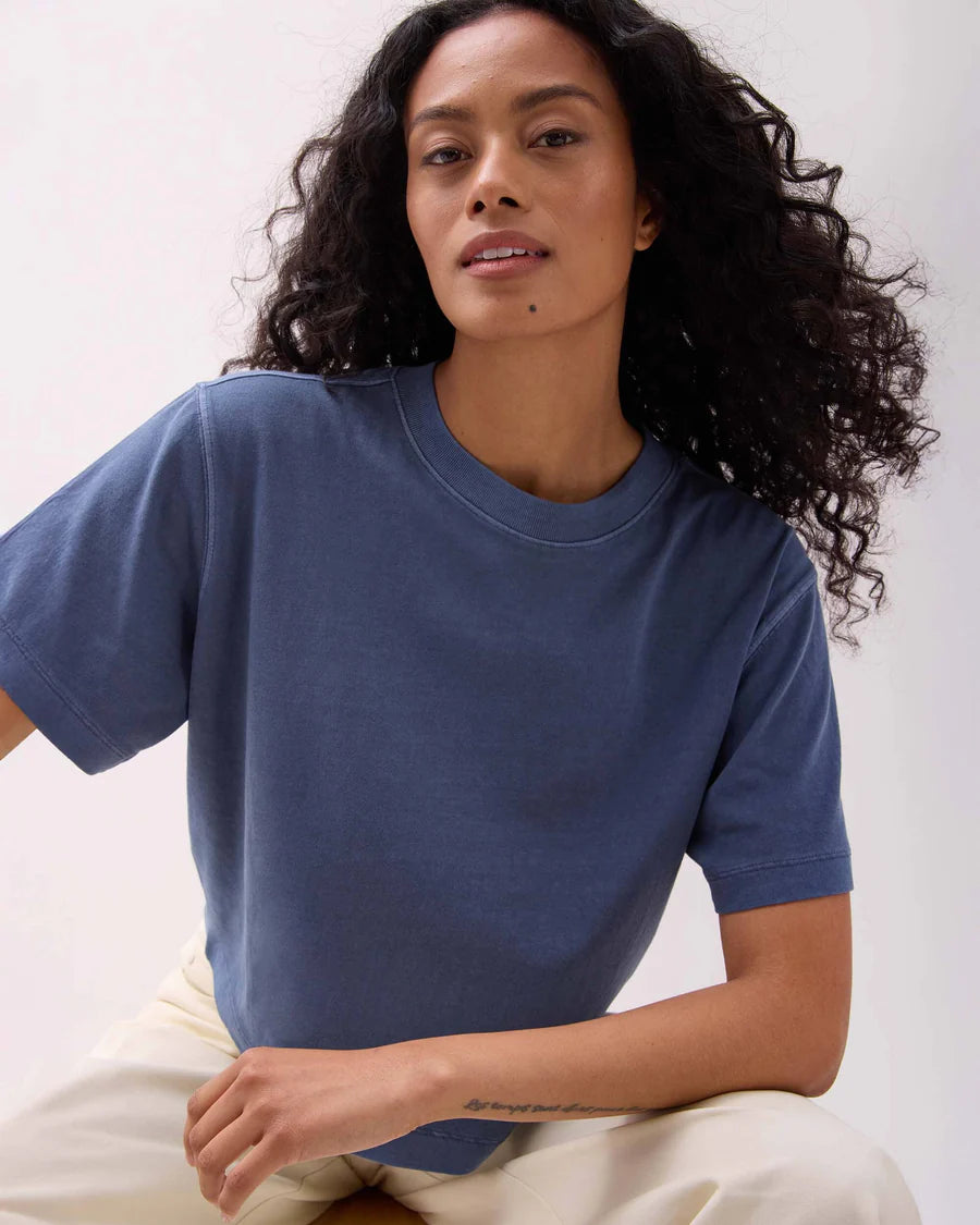 Woman wearing a blue t-shirt against a white background