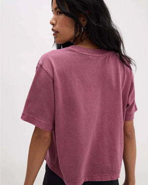 Person wearing a pink t-shirt against a white background