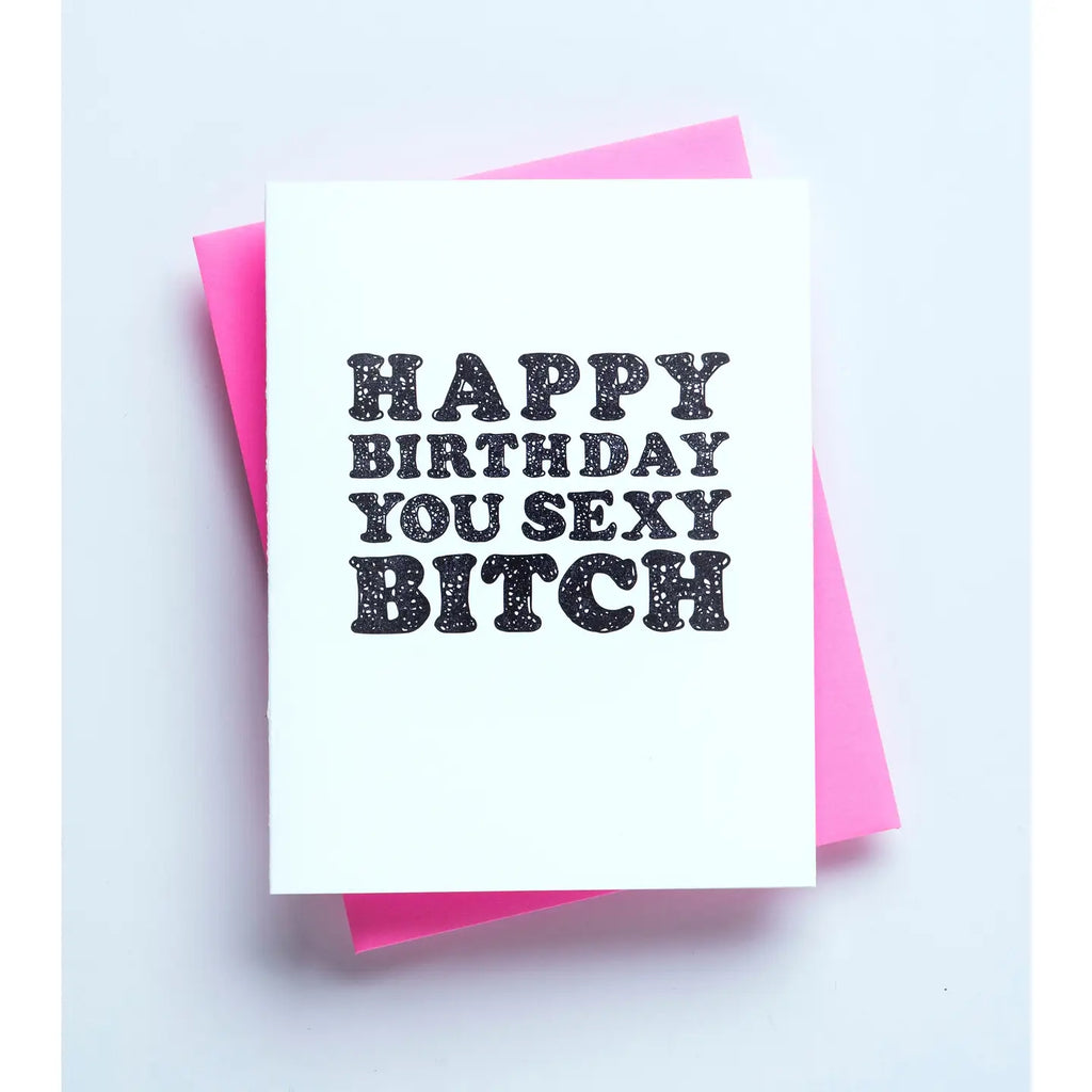 Card with 'Happy Birthday You Sexy Bitch' text on a white background with pink envelope.