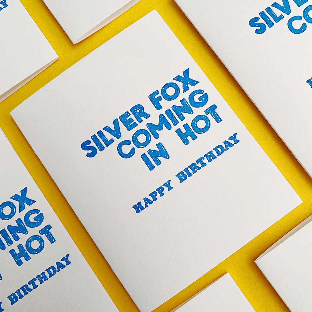 White cards with blue text 'Silver Fox Coming in Hot Happy Birthday' on a yellow border.