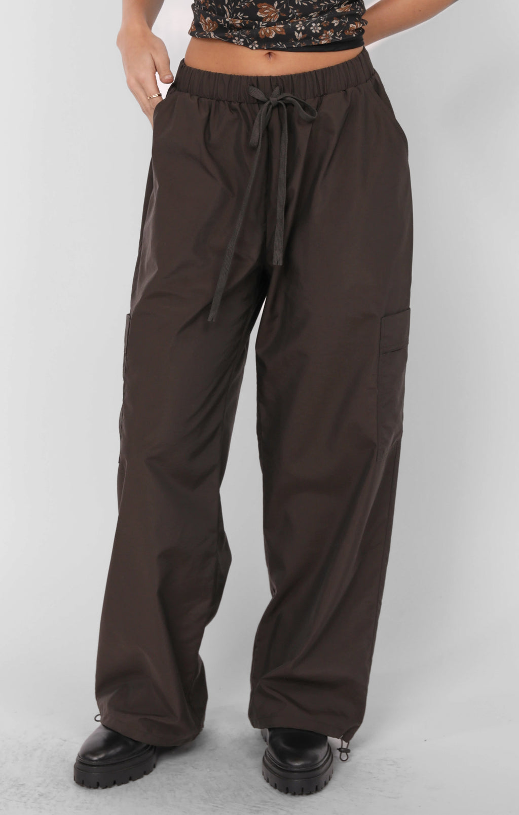 Brown wide-leg pants worn by a person on a white background