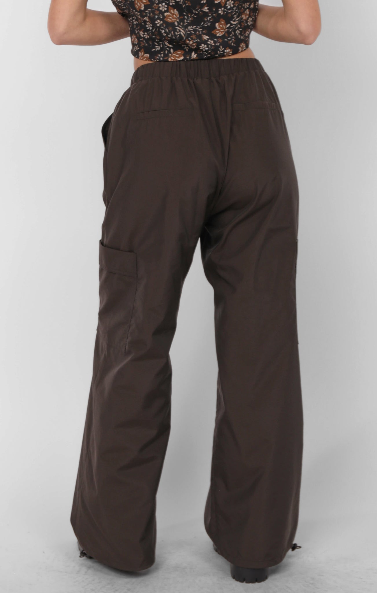Brown wide-leg pants worn by a person on a white background