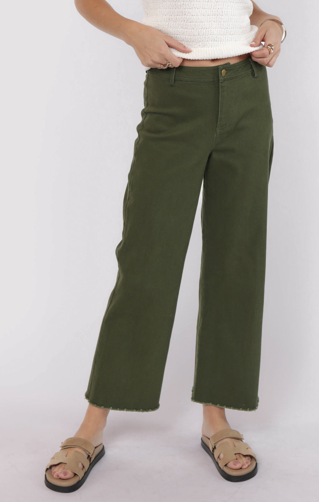 Person wearing green pants on a white background