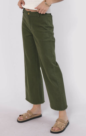Person wearing green pants on a white background
