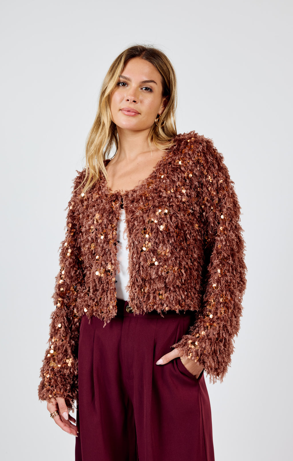 Joelle faux fur sequin mix jacket. This unique jacket features a playful mix of sequins and faux fur, adding a touch of whimsy to any outfit. Stay warm and stylish with this quirky statement piece!