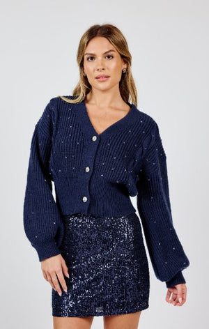 Get ready for a "gem" of a time with Sadie & Sage's Museum Date cardigan. This bejeweled button masterpiece adds a touch of elegance to any outfit. Perfect for a night out or a cozy night in, this cardigan is sure to elevate your style (and mood) to new heights!