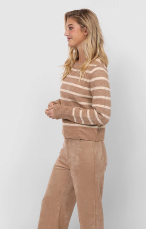 Woman wearing a brown and beige striped sweater with matching pants on a white background