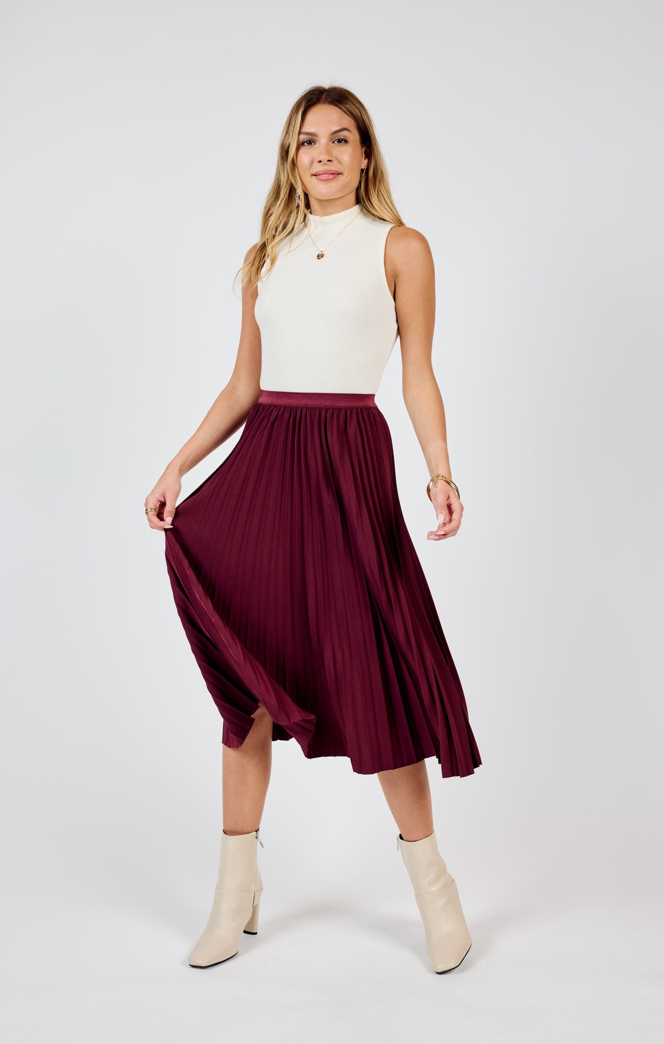 Get ready to make a statement in the Sadie & Sage Silent Streets pleated midi skirt! With its unique pleated design, this skirt adds a touch of playfulness and personality to any outfit. Perfect for standing out in a crowd and bringing a smile to everyone's face. (Warning: may cause excessive twirling and compliments!)