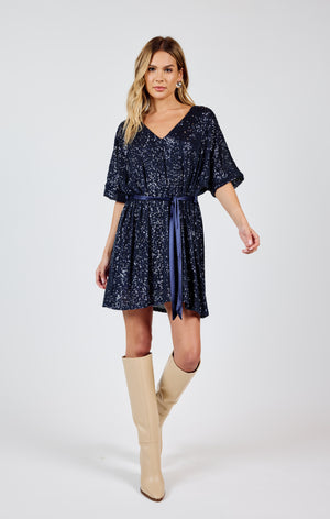 Stand out from the crowd in this dazzling v-neck sequin dress by Sadie &Sage. The tie belt adds the perfect touch of flair to this sky high dress. Bring on the compliments (and the dance floor)!