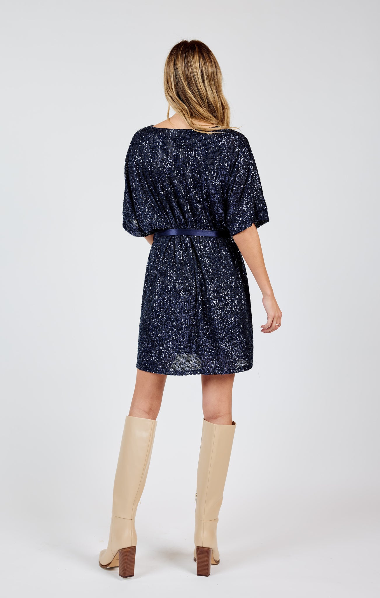 Stand out from the crowd in this dazzling v-neck sequin dress by Sadie &Sage. The tie belt adds the perfect touch of flair to this sky high dress. Bring on the compliments (and the dance floor)!