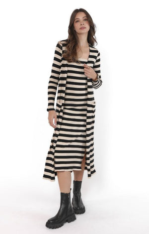 Woman wearing a black and white striped dress on a white background