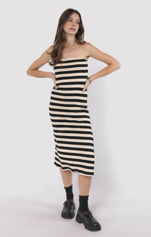 Woman wearing a black and white striped dress on a white background