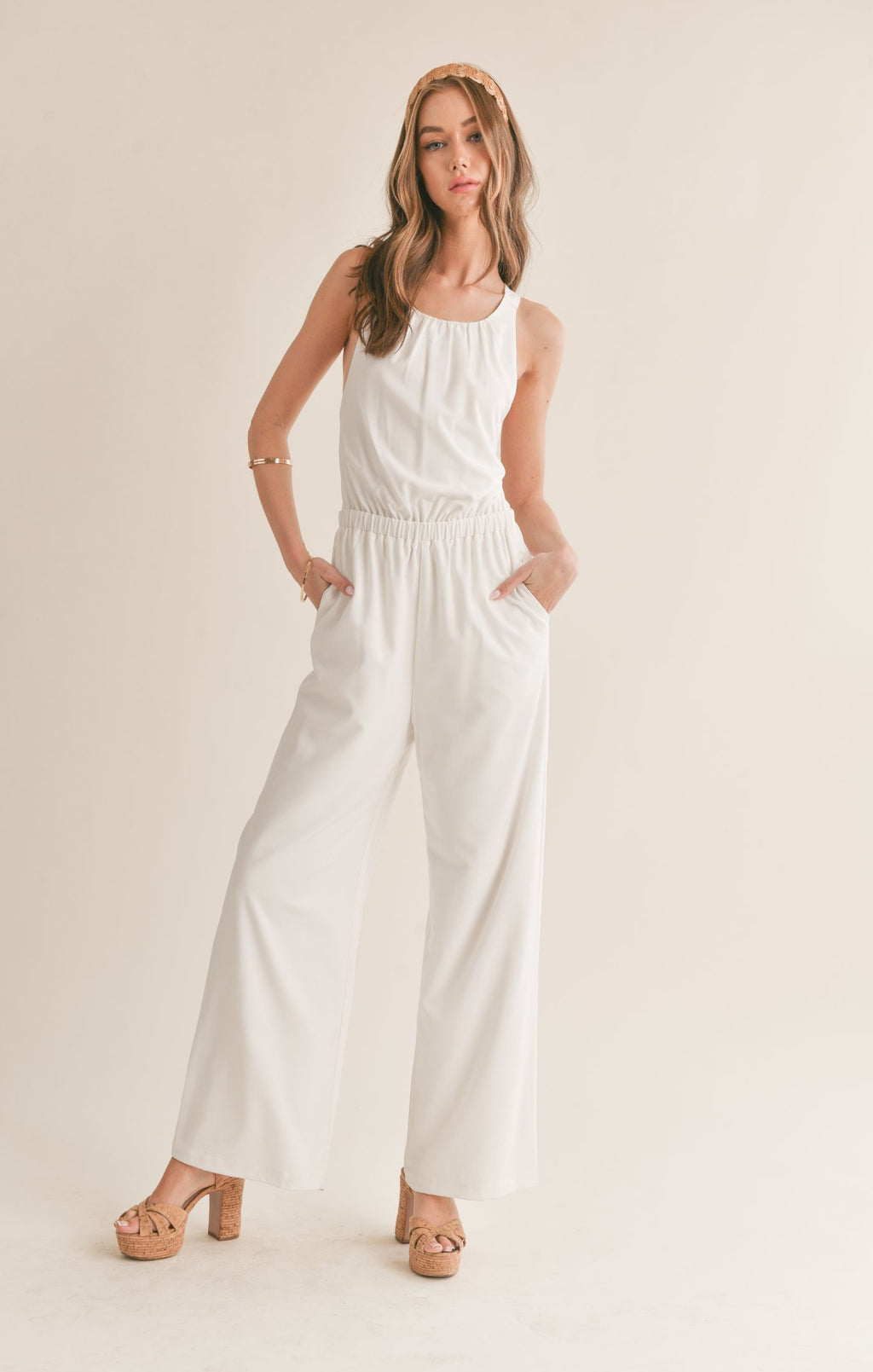 Feel confident and chic in the Sage the Label Assured jumpsuit with a playful crossed back. Perfect for a night out or a casual day, this jumpsuit effortlessly combines style and comfort. Say goodbye to boring outfits and hello to a quirky, fun look!