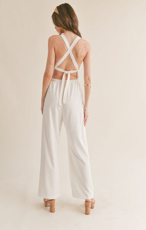 Feel confident and chic in the Sage the Label Assured jumpsuit with a playful crossed back. Perfect for a night out or a casual day, this jumpsuit effortlessly combines style and comfort. Say goodbye to boring outfits and hello to a quirky, fun look!