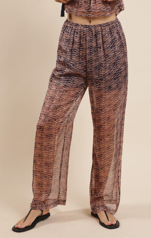 Step into effortless style with the Sage the Label Canyon Echoes Pant. These wide-leg sheer pants flow with every move, blending comfort and breezy elegance. Perfect for sunny days or layering up for a chic look, they add a playful twist to your wardrobe while keeping things light and airy. Embrace the freedom of movement and let your outfit echo your carefree spirit.