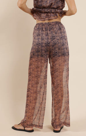 Step into effortless style with the Sage the Label Canyon Echoes Pant. These wide-leg sheer pants flow with every move, blending comfort and breezy elegance. Perfect for sunny days or layering up for a chic look, they add a playful twist to your wardrobe while keeping things light and airy. Embrace the freedom of movement and let your outfit echo your carefree spirit.