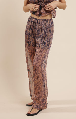Step into effortless style with the Sage the Label Canyon Echoes Pant. These wide-leg sheer pants flow with every move, blending comfort and breezy elegance. Perfect for sunny days or layering up for a chic look, they add a playful twist to your wardrobe while keeping things light and airy. Embrace the freedom of movement and let your outfit echo your carefree spirit.