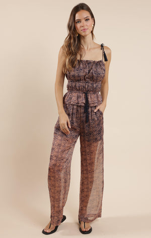 Step into effortless style with the Sage the Label Canyon Echoes Pant. These wide-leg sheer pants flow with every move, blending comfort and breezy elegance. Perfect for sunny days or layering up for a chic look, they add a playful twist to your wardrobe while keeping things light and airy. Embrace the freedom of movement and let your outfit echo your carefree spirit.