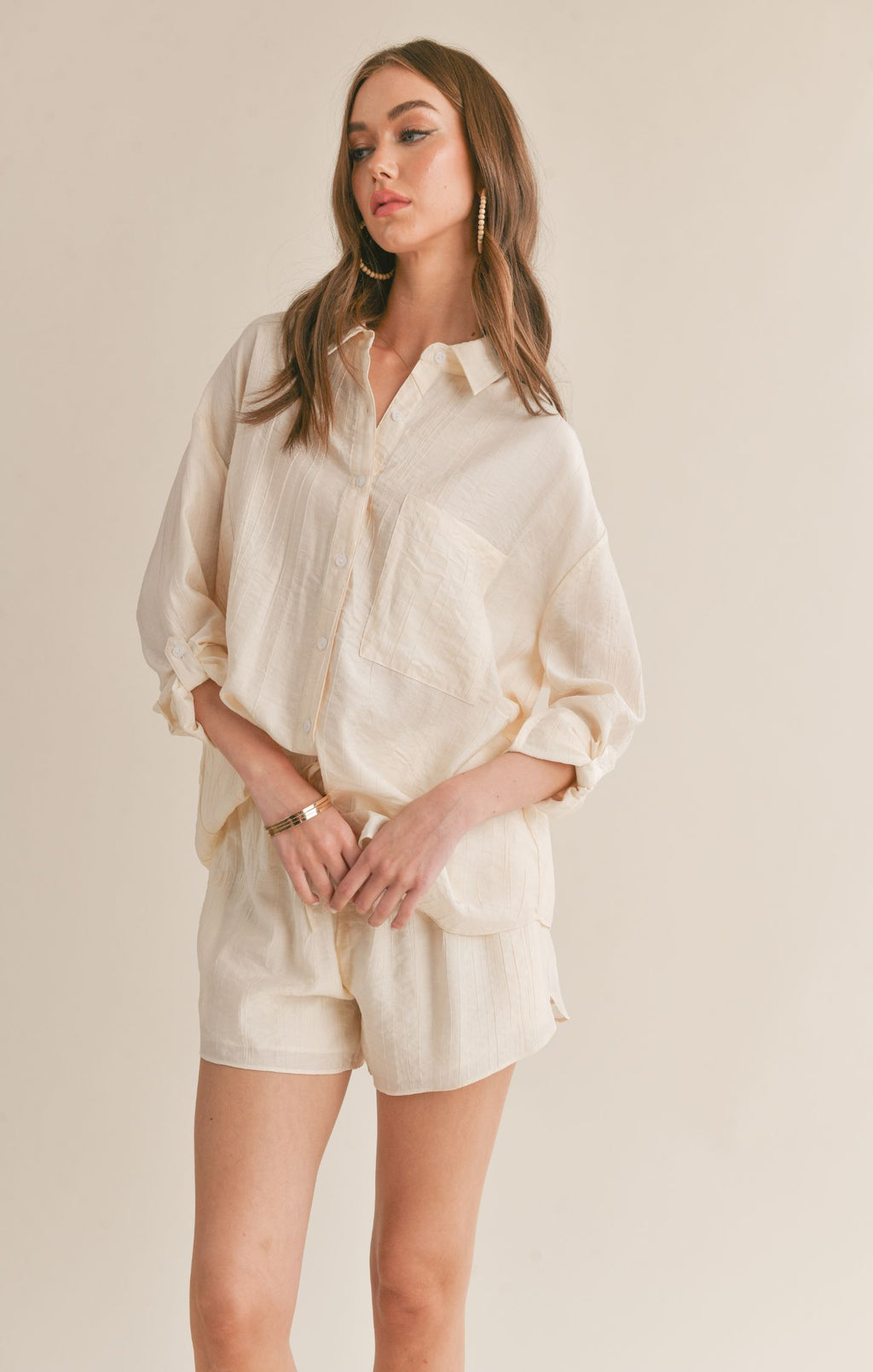 Sage the Label's Clementine shirt features a playful cut out back and trendy button-up design. Perfect for a fun and stylish look.