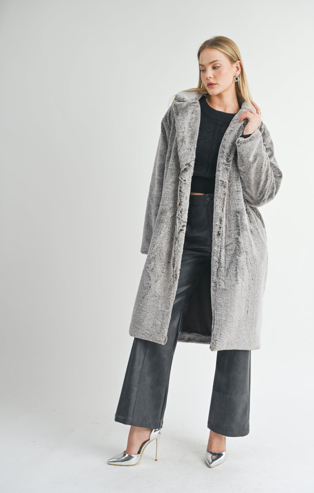 Brave the cold in style with Sage the Label's Daring 2 tone vegan fur coat. Stay cozy and cruelty-free with this playful and unique addition to your wardrobe. (Fur real!)