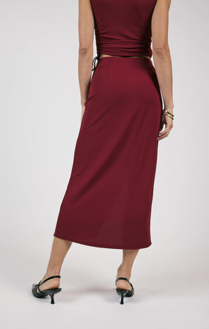 Unleash your fiery spirit with Sage the Label's Pleated Overlap Knit Midi Skirt. This playful skirt features unique pleats and a midi length for an effortlessly stylish look. Perfect for adding a touch of quirkiness to your wardrobe.