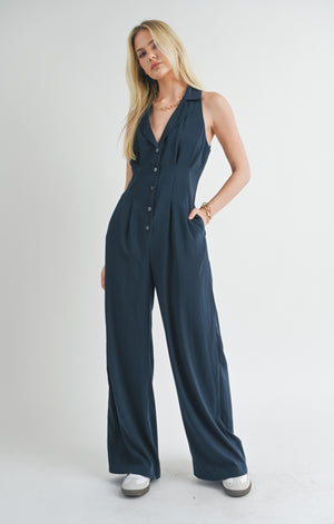 Elevate your style game with the Finest Touch halter jumpsuit from Sage the Label. This trendy one-piece features a flattering halter neckline and is perfect for any occasion. Make a statement with ease and show off your playful side in this unique piece.