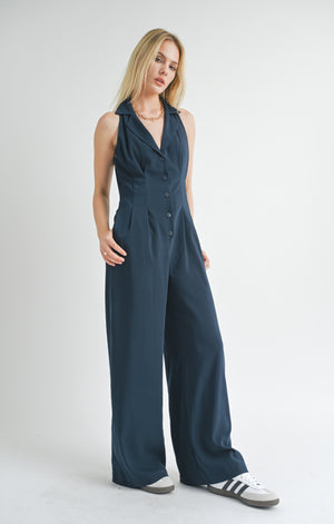 Elevate your style game with the Finest Touch halter jumpsuit from Sage the Label. This trendy one-piece features a flattering halter neckline and is perfect for any occasion. Make a statement with ease and show off your playful side in this unique piece.