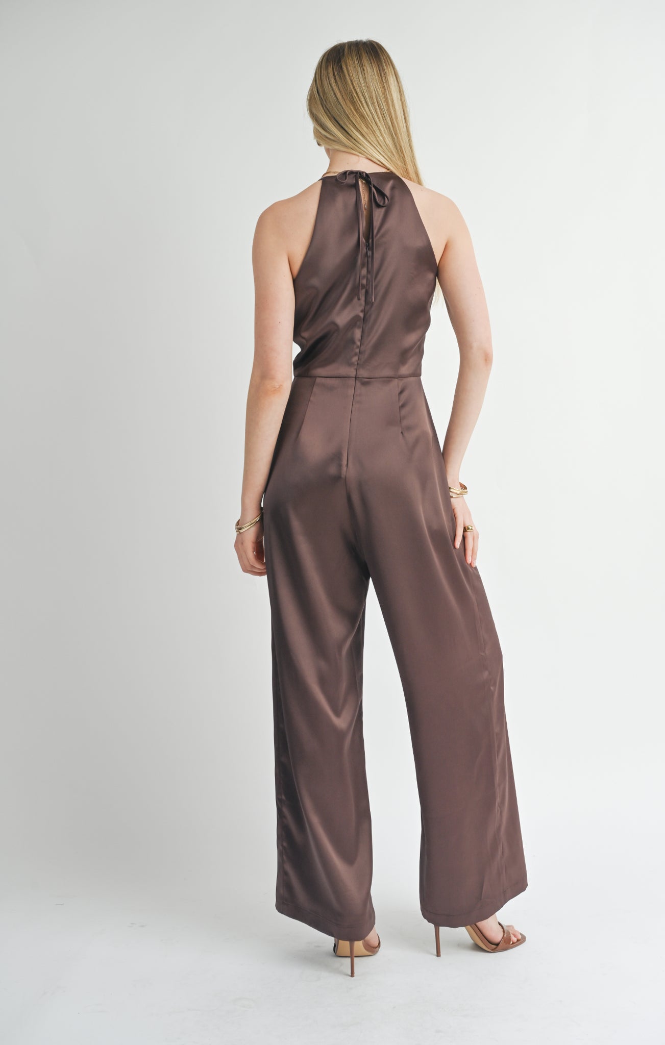 Introducing the Sage the Label Flawless jumpsuit. This halter jumpsuit is a game-changer for your wardrobe. Say goodbye to boring outfits and hello to effortless style. Perfect for any occasion, this jumpsuit will make you look and feel flawless. Get ready to turn heads!