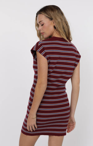 Woman wearing a striped dress on a white background