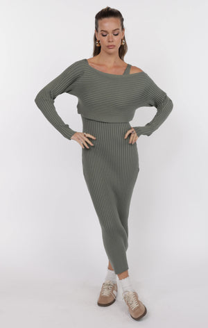 Woman wearing a green ribbed knit outfit on a white background
