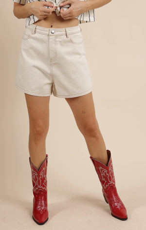 These high-waist denim shorts from Sage the Label bring a fun twist with their bold contrast stitching. Perfect for sunny days, they combine a flattering fit with eye-catching details that make every outfit pop. Get ready to turn heads and embrace your playful side in style!