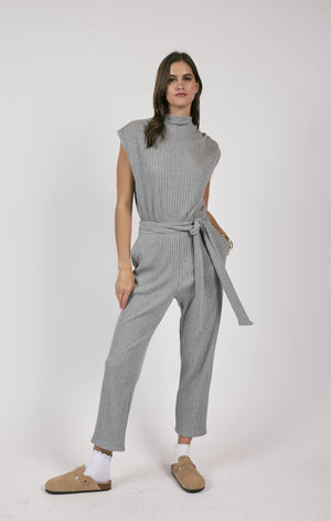 This rib knit jumpsuit hugs your curves and adds a touch of playfulness with a belted waist. Less is truly more with this versatile piece, perfect for a variety of occasions.