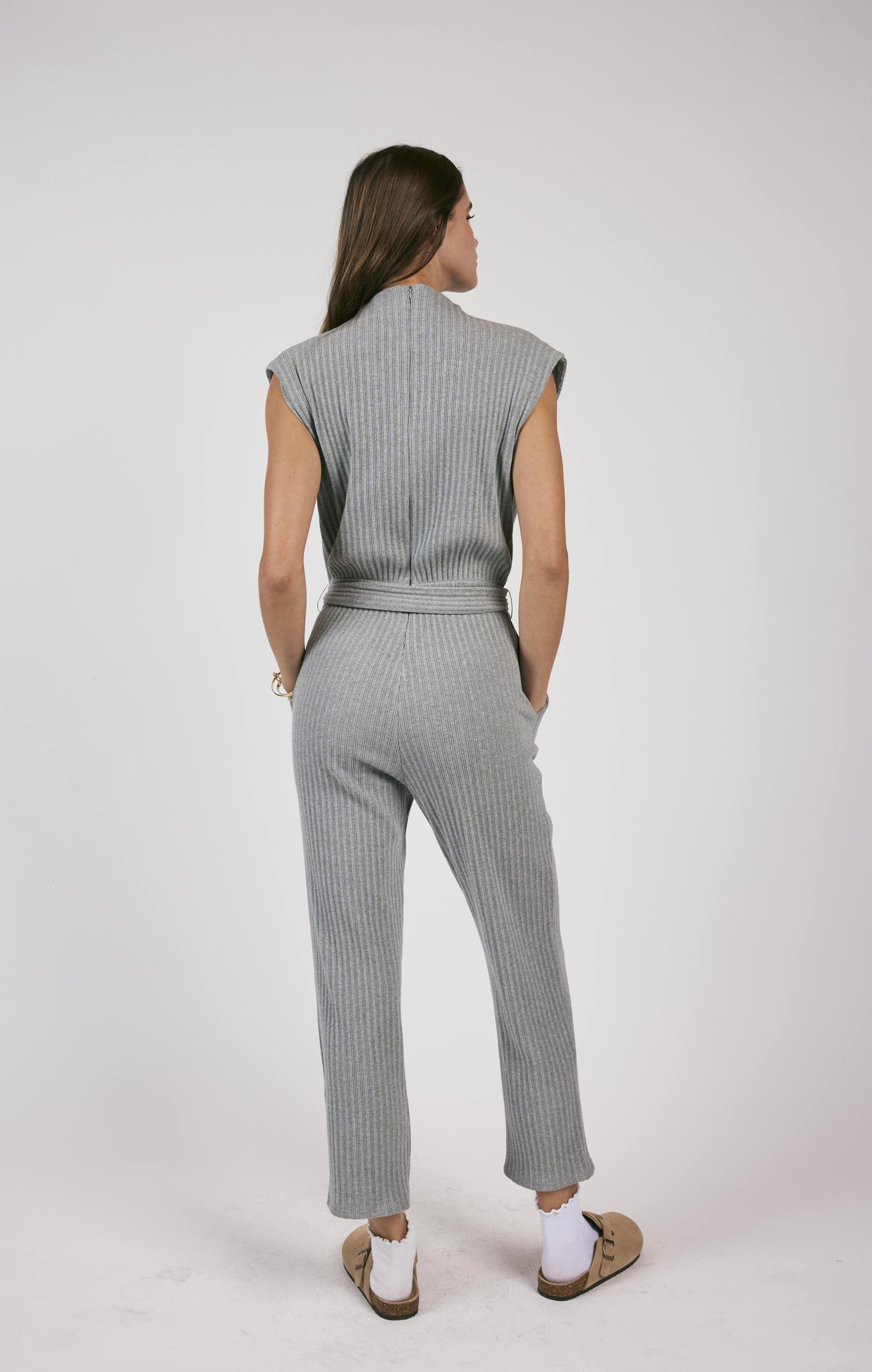 This rib knit jumpsuit hugs your curves and adds a touch of playfulness with a belted waist. Less is truly more with this versatile piece, perfect for a variety of occasions.