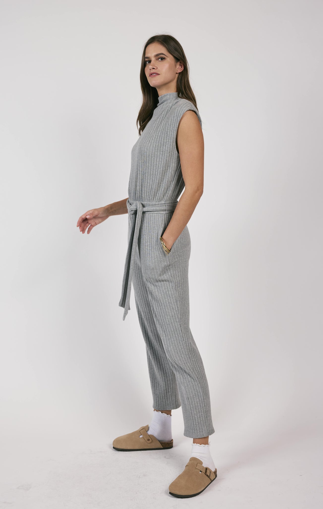 This rib knit jumpsuit hugs your curves and adds a touch of playfulness with a belted waist. Less is truly more with this versatile piece, perfect for a variety of occasions.