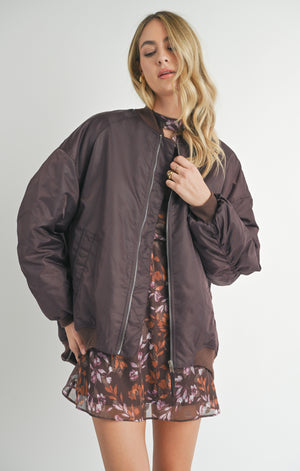 Unleash your inner cool with Sage the Label's Mila bomber jacket. Featuring shirred sleeves and an oversized fit, this jacket will keep you warm and stylish. Make a statement with this unique and playful piece.