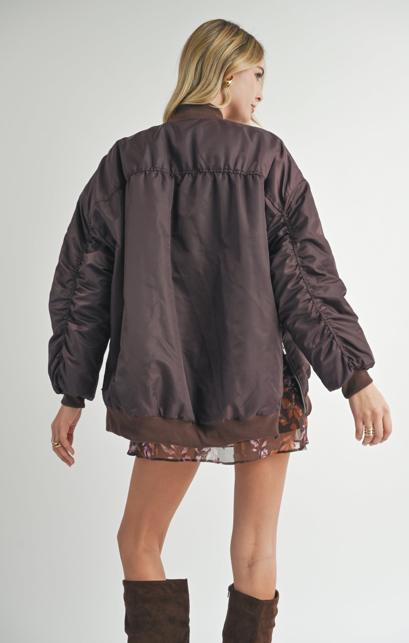 Unleash your inner cool with Sage the Label's Mila bomber jacket. Featuring shirred sleeves and an oversized fit, this jacket will keep you warm and stylish. Make a statement with this unique and playful piece.