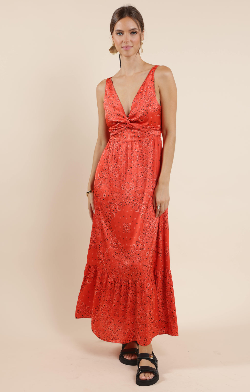 This playful satin maxi dress features a vibrant bandana print that adds a fun twist to a classic silhouette. Its smooth, flowing fabric drapes beautifully, making it perfect for twirling at summer parties or casual outings. Embrace effortless style with a dress that’s as lively and unique as you are.