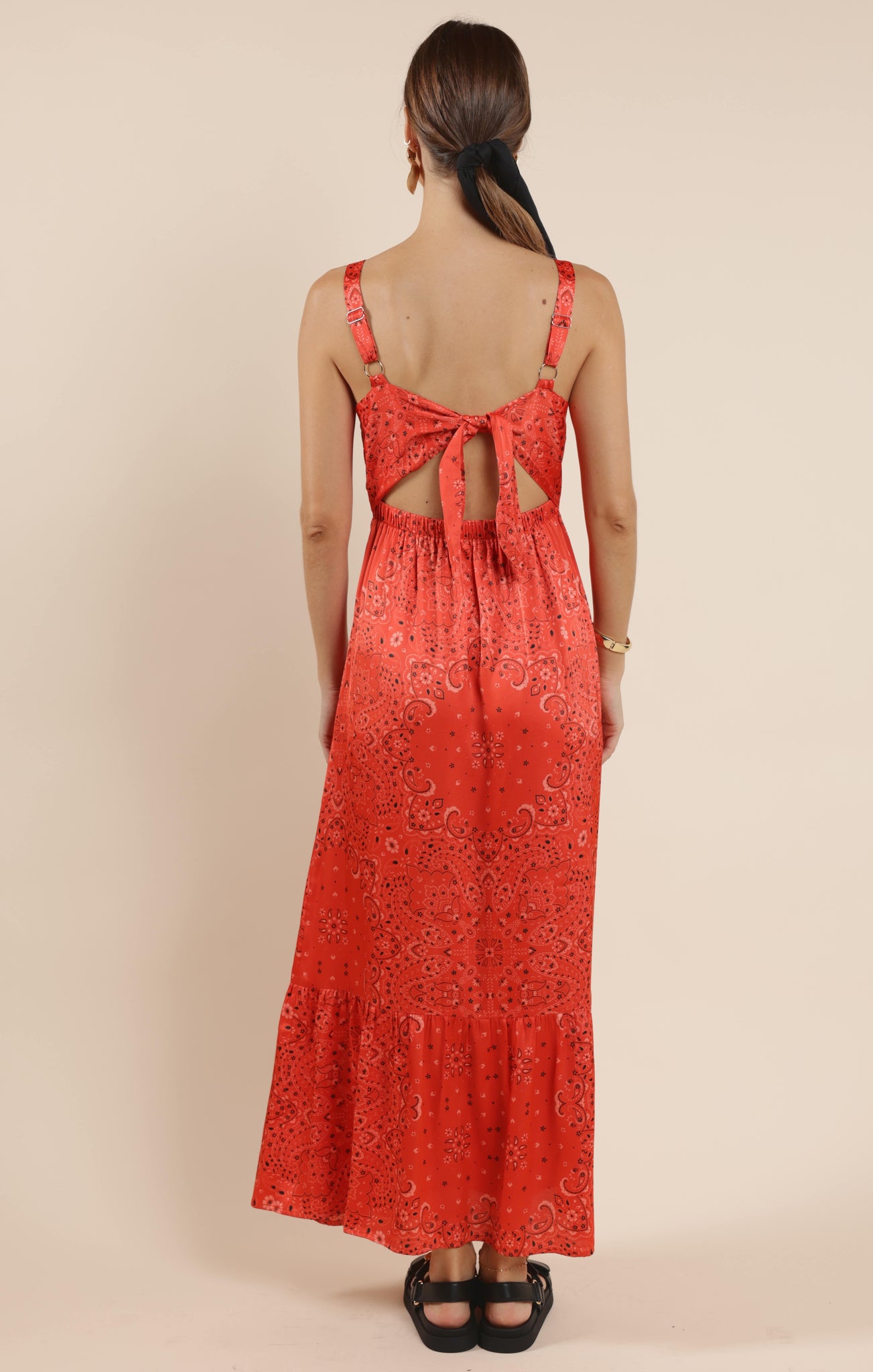 This playful satin maxi dress features a vibrant bandana print that adds a fun twist to a classic silhouette. Its smooth, flowing fabric drapes beautifully, making it perfect for twirling at summer parties or casual outings. Embrace effortless style with a dress that’s as lively and unique as you are.