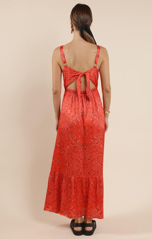 This playful satin maxi dress features a vibrant bandana print that adds a fun twist to a classic silhouette. Its smooth, flowing fabric drapes beautifully, making it perfect for twirling at summer parties or casual outings. Embrace effortless style with a dress that’s as lively and unique as you are.