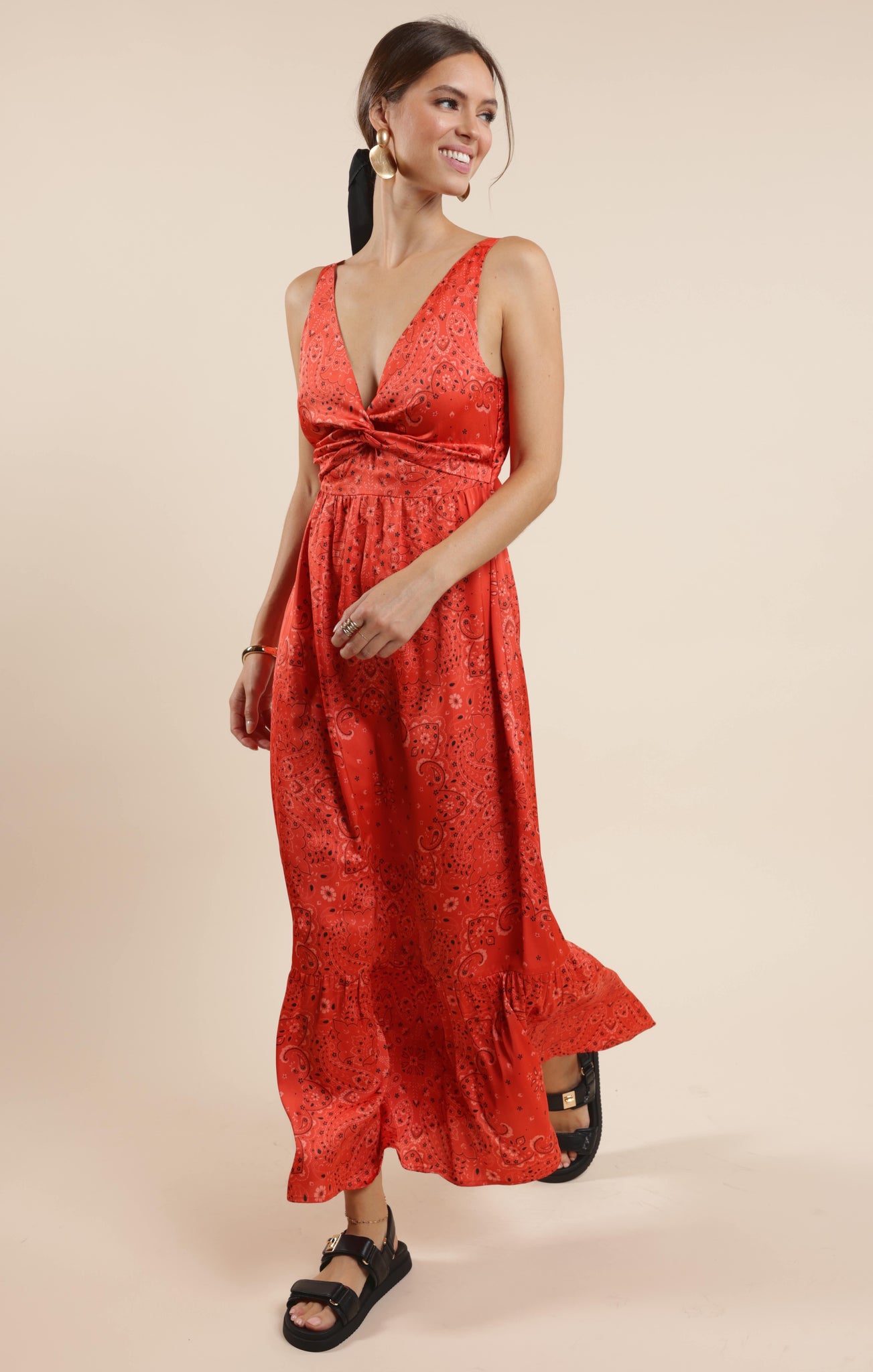 This playful satin maxi dress features a vibrant bandana print that adds a fun twist to a classic silhouette. Its smooth, flowing fabric drapes beautifully, making it perfect for twirling at summer parties or casual outings. Embrace effortless style with a dress that’s as lively and unique as you are.