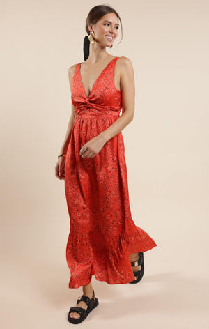 This playful satin maxi dress features a vibrant bandana print that adds a fun twist to a classic silhouette. Its smooth, flowing fabric drapes beautifully, making it perfect for twirling at summer parties or casual outings. Embrace effortless style with a dress that’s as lively and unique as you are.
