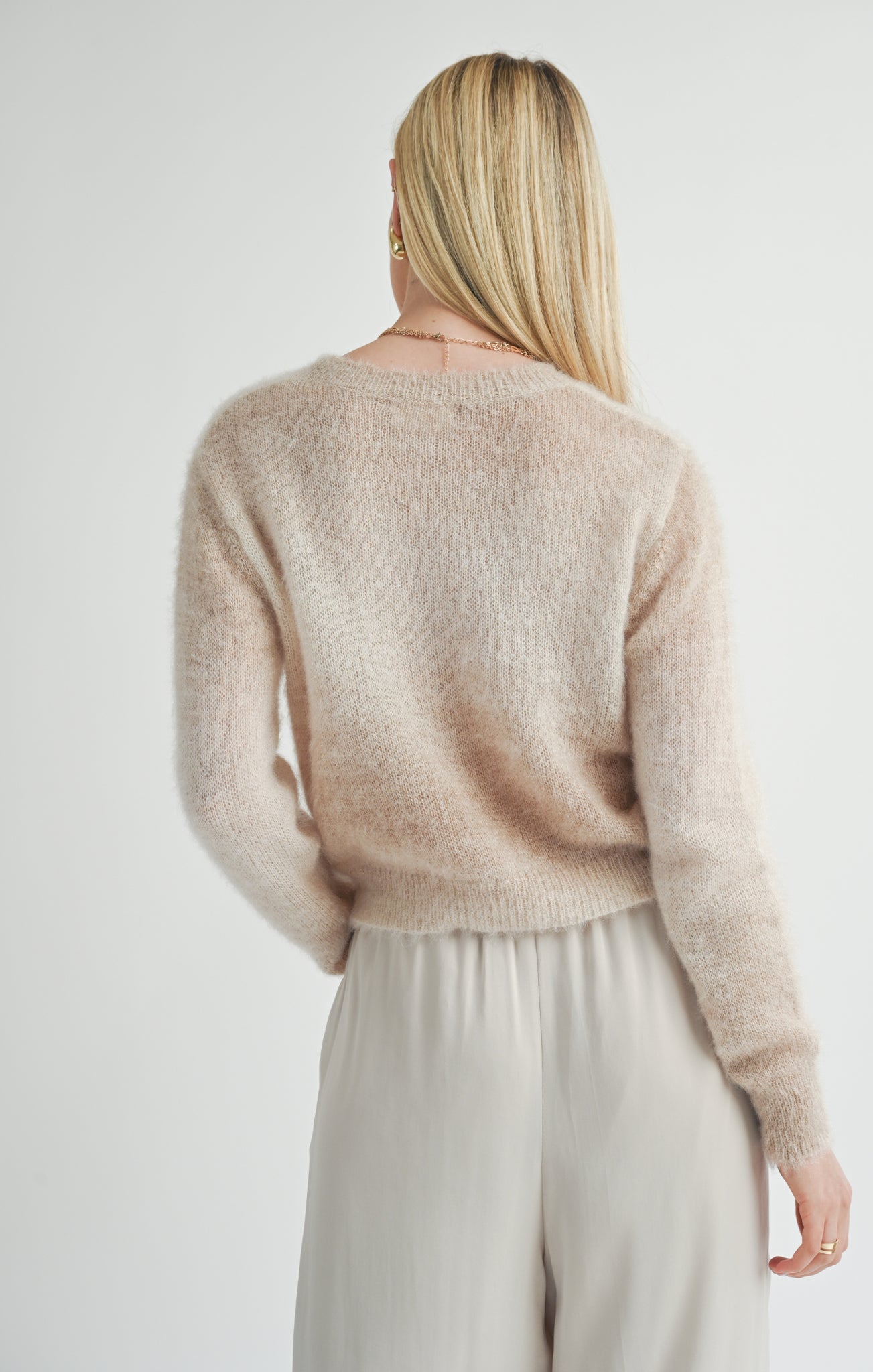 Wrap yourself in celestial style with the Sage the Label Reach for the Stars ombre sweater. This playful pullover features a unique ombre design and is the perfect statement piece for any starry-eyed fashionista. Reach for the stars and add this quirky sweater to your wardrobe today!