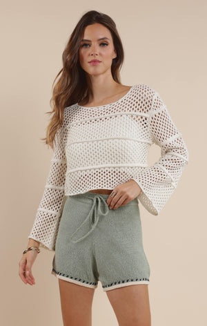 Embrace boho-chic vibes with our Poppy crochet bell sleeve sweater! This whimsical piece features dramatic bell sleeves that dance with your every move. Perfect for festival season or adding a touch of free-spirited charm to your everyday wardrobe. The intricate crochet detailing makes this sweater as unique as you are!