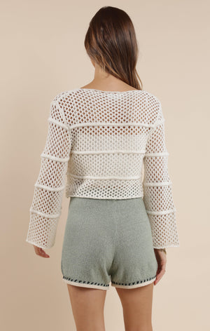 Embrace boho-chic vibes with our Poppy crochet bell sleeve sweater! This whimsical piece features dramatic bell sleeves that dance with your every move. Perfect for festival season or adding a touch of free-spirited charm to your everyday wardrobe. The intricate crochet detailing makes this sweater as unique as you are!