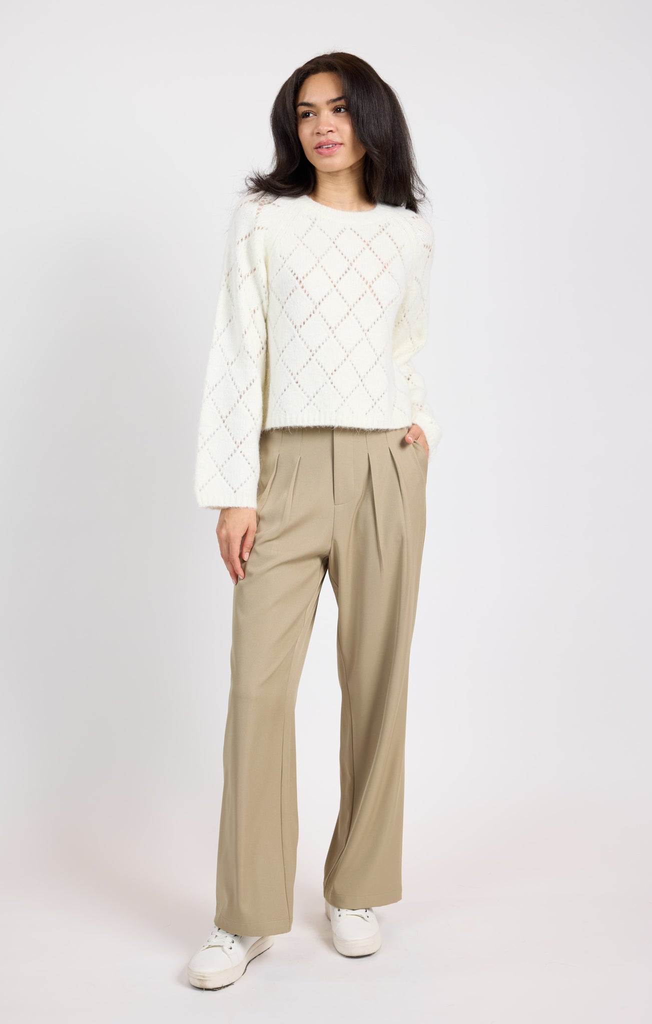 Stay cozy and chic in the Selena Diamond Pointelle Sweater by Sage the Label. With intricate diamond pointelle stitching, this sweater adds a touch of elegance to any outfit. Perfect for layering on chilly days or dressing up for a night out.