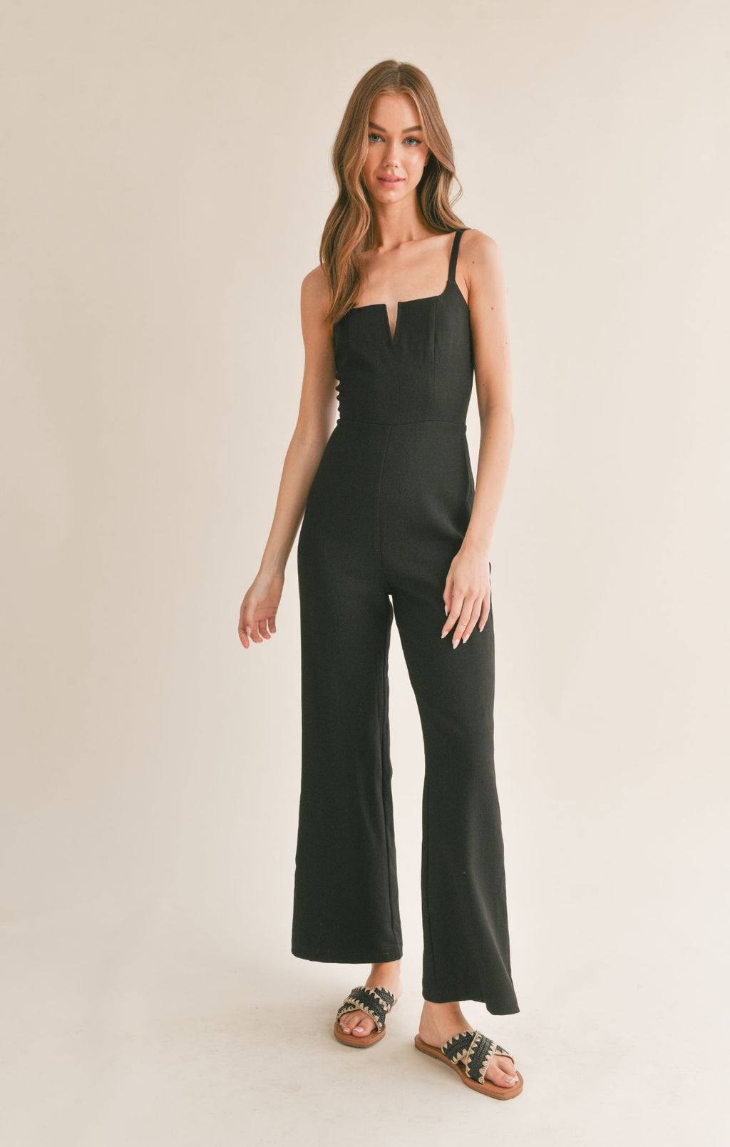 Be effortlessly chic in Sage the Label's Serene v cutout jumpsuit. This unique one-piece features a playful v cutout design, perfect for showing off your favorite accessories. Perfect for any occasion, this jumpsuit offers both style and comfort.