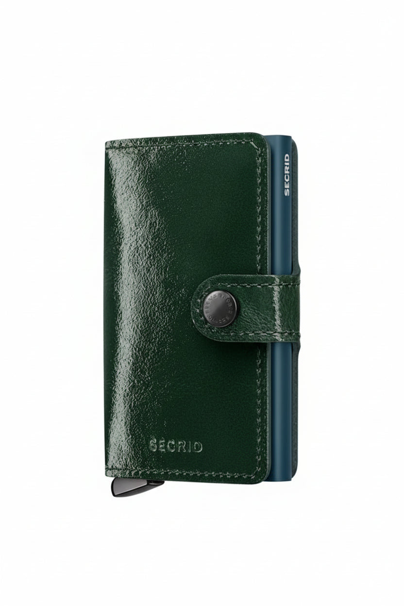 Black leather wallet with a button closure on a beige background